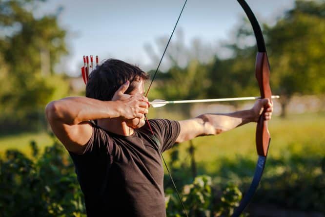 Someone shooting a bow and arrow at an range, one of the best places for archery in London