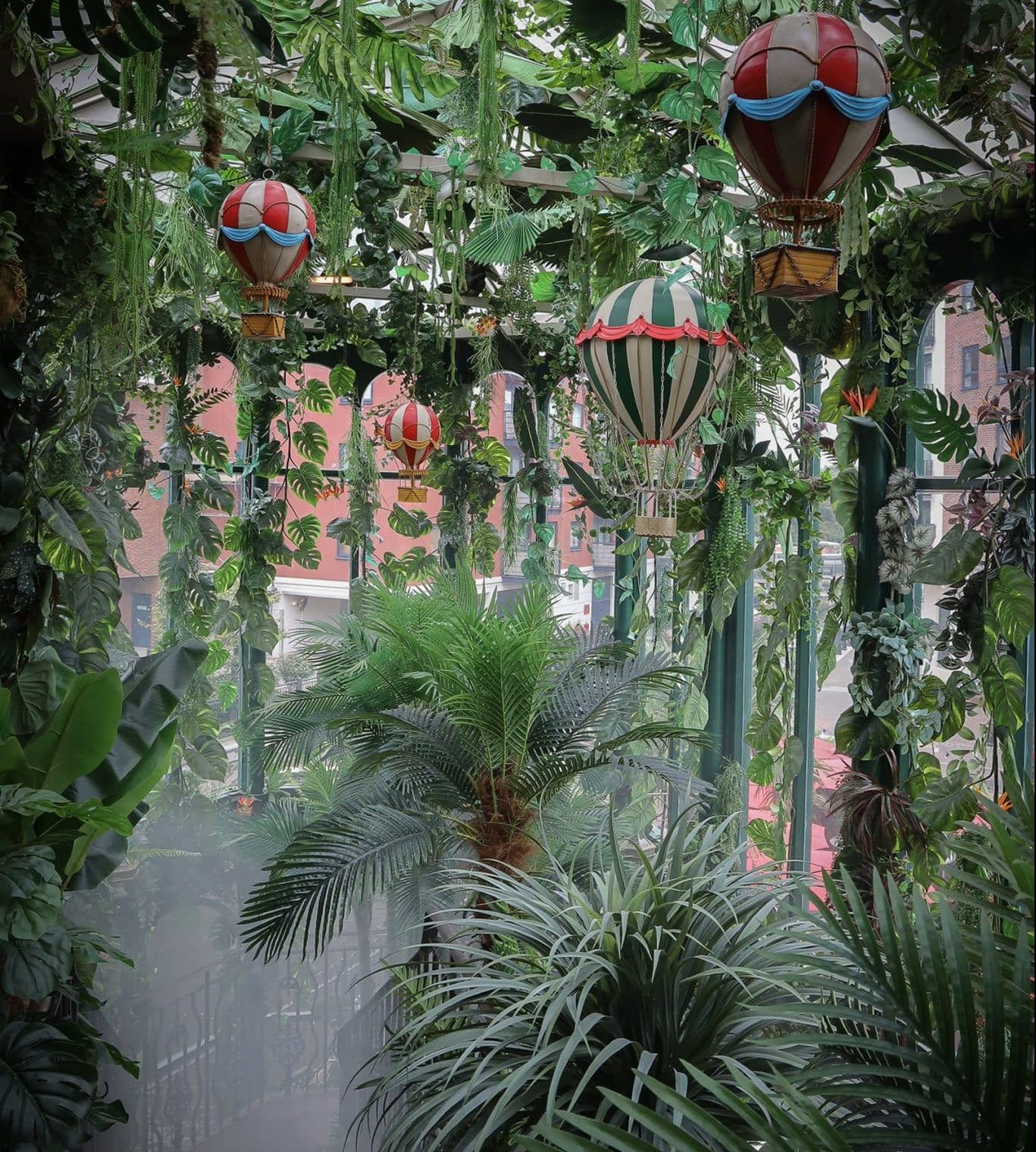 The rainforest dotted with miniature hot air balloons in the entrance-way to Incognito