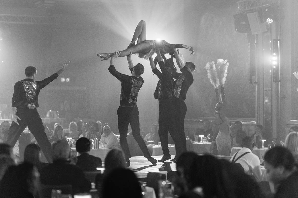 dancers carrying a woman in a cabaret show