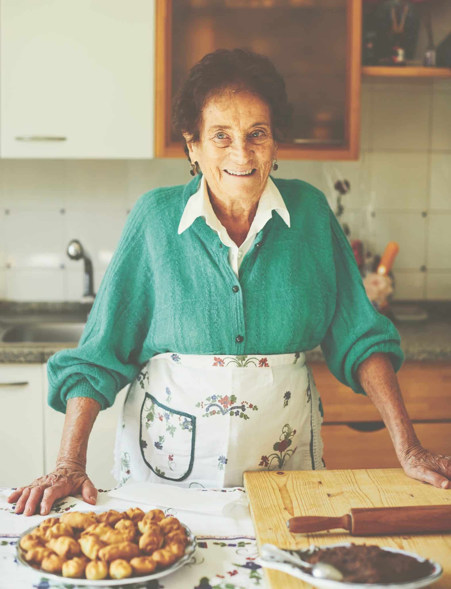 nonna Maria of the Pasta Grannies standing in a kitchen
