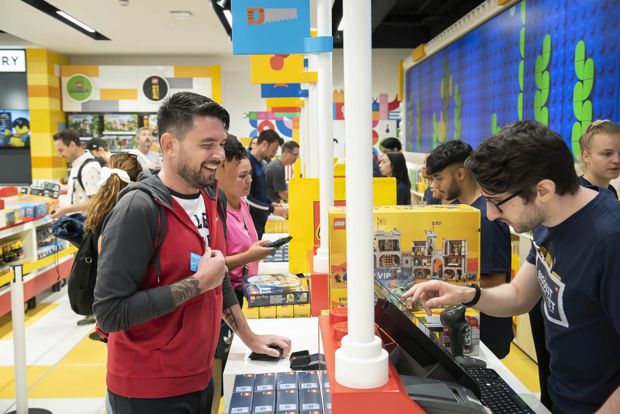 A customer purchases LEGO products on the opening day of the LEGO Store Leicester Square, London