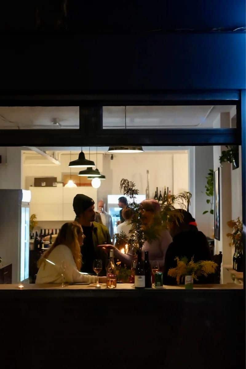 people sat inside at Dan's wine bar, one of the stops on the Dalston Wine Mile