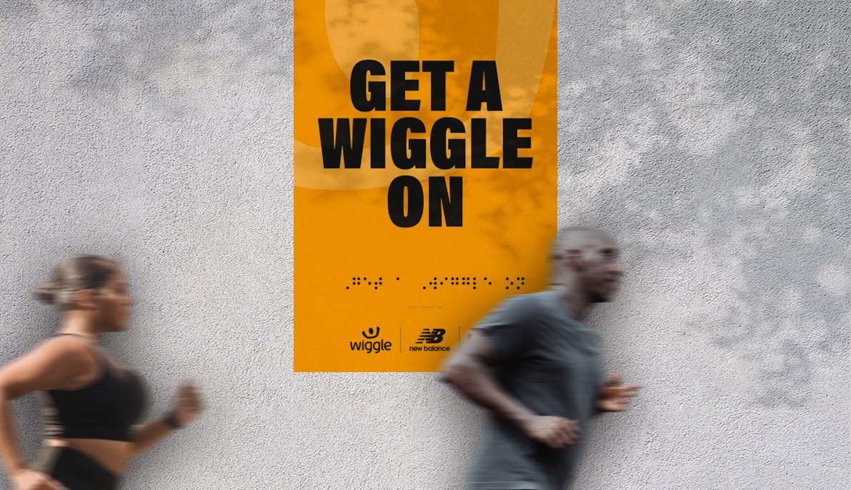runners running past a braille banner