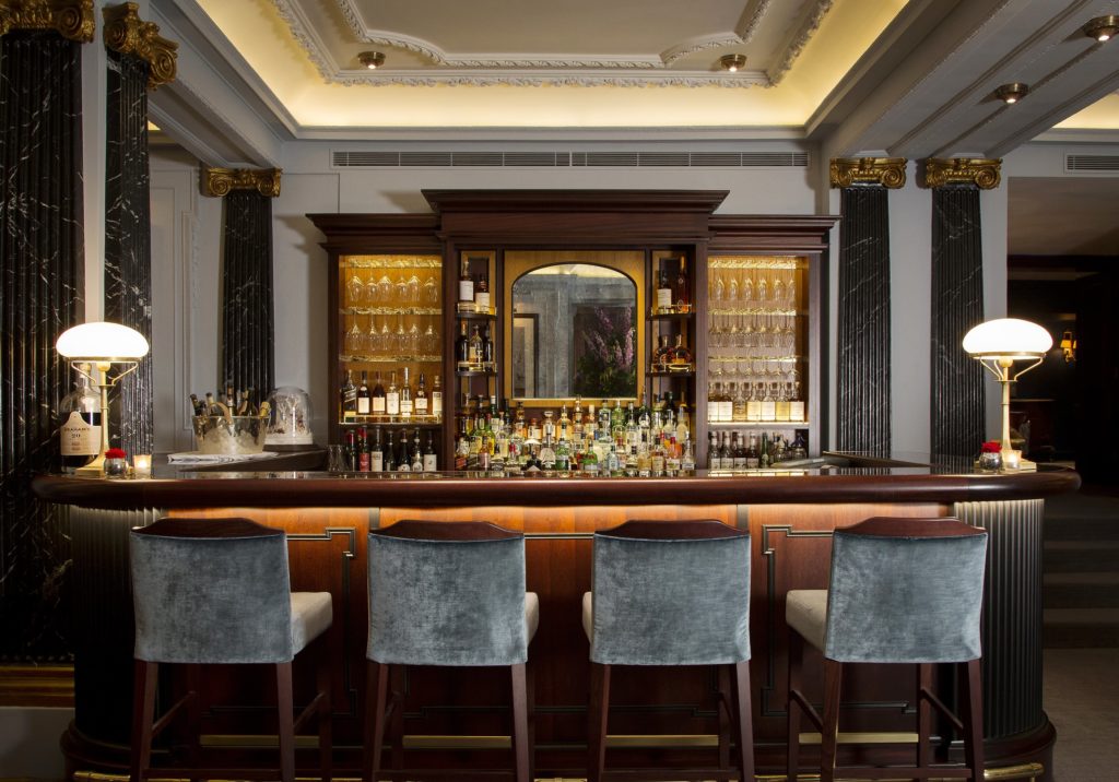grey velour stools at the bar at the Game Bird