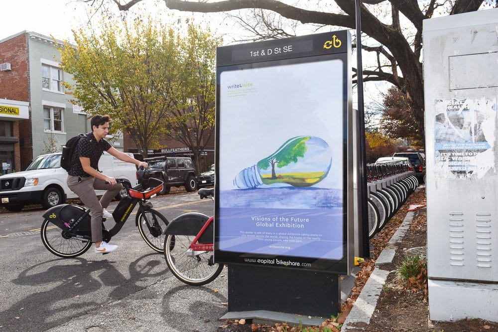 the art from the visions of the future global exhibition being displayed at a bike sharing station in Washington DC