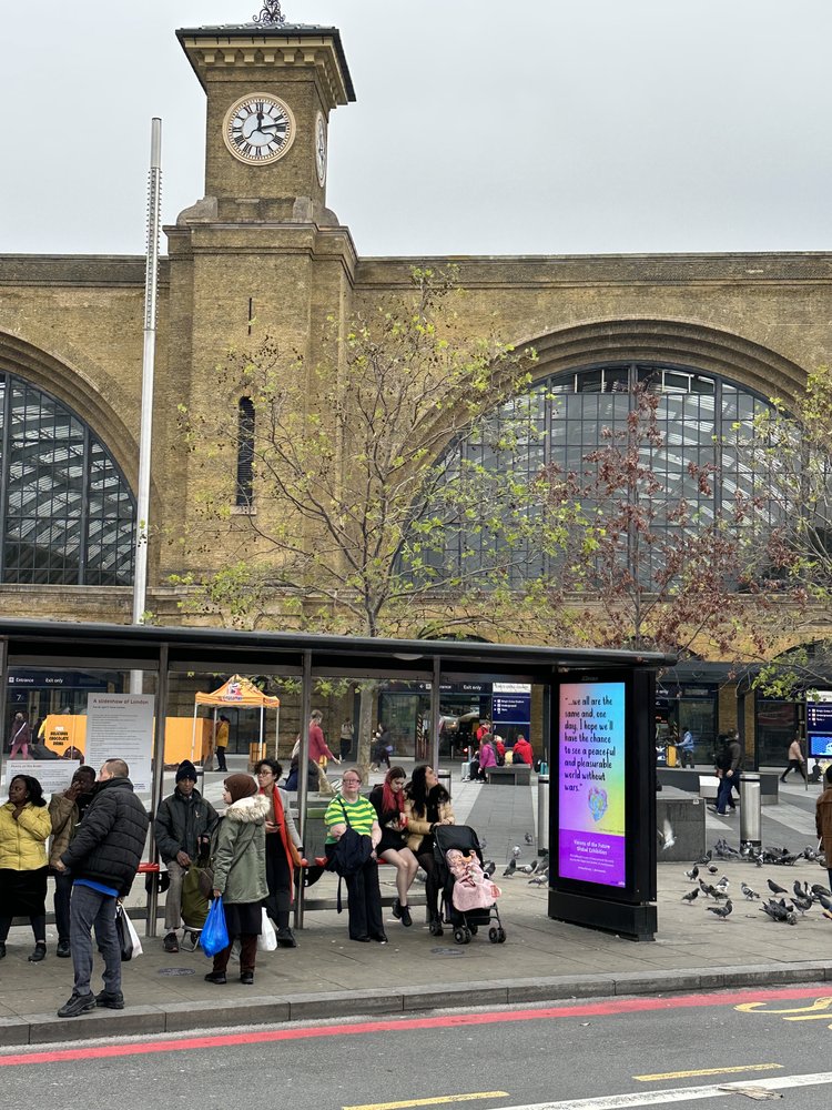 an artwork displayed at a bus stop outside a London station