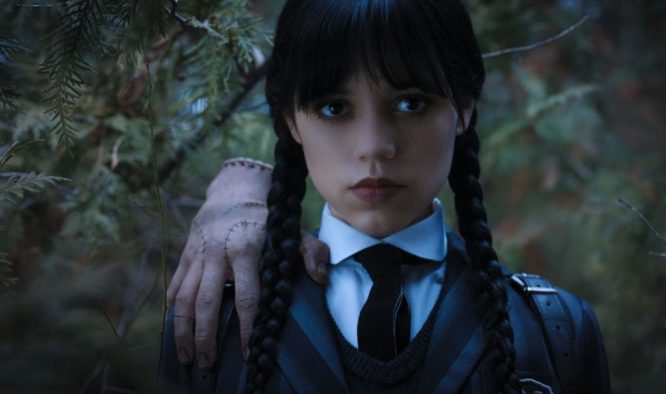 Jenna Ortega as Wednesday Addams, staring at the viewer, with Thing perched atop her shoulder