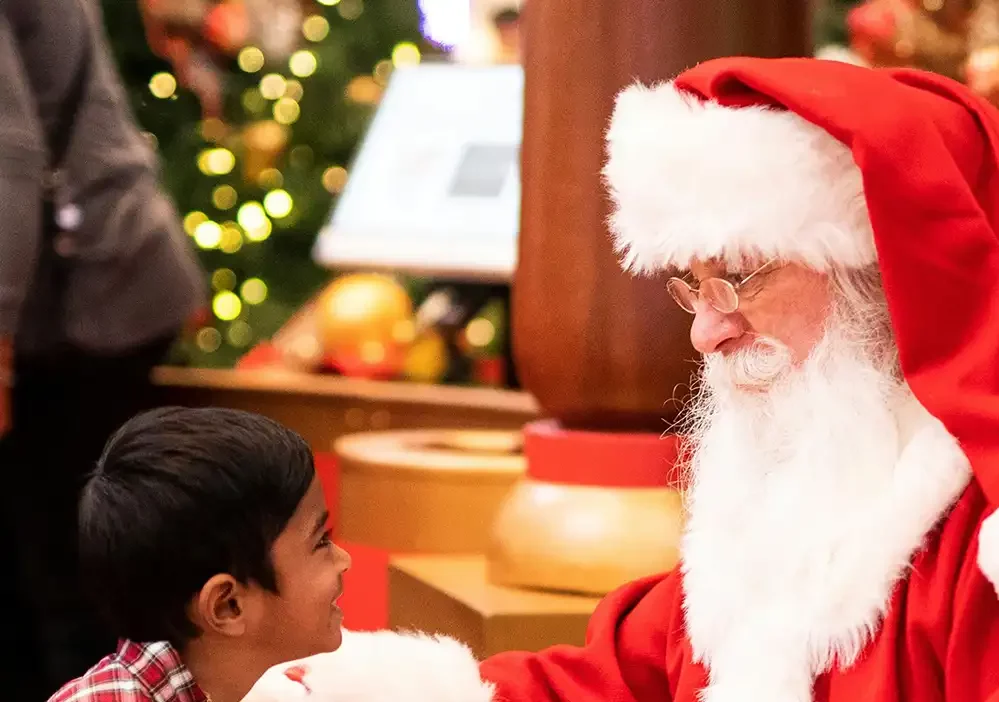 santa and a small child at santa grottos at fujifilm house of photography