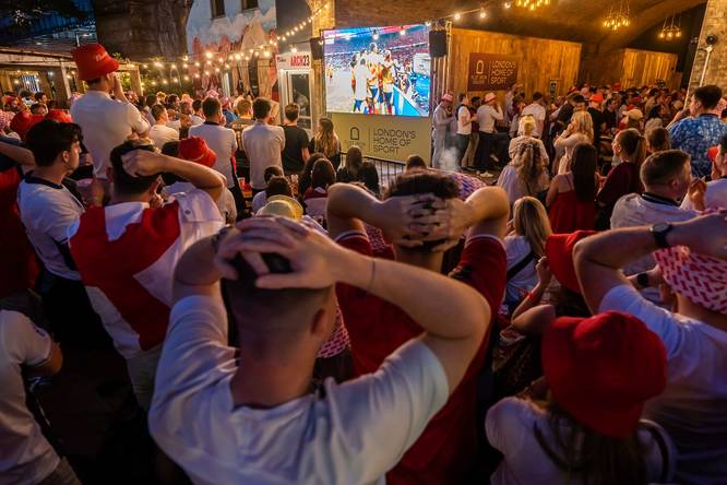Fans flocked round the screen at Flat Iron Square watching a football match