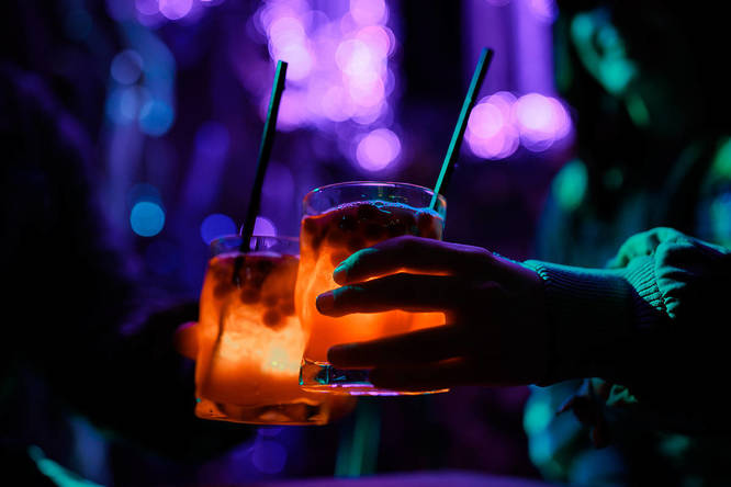 two cocktails with lights in at Avora