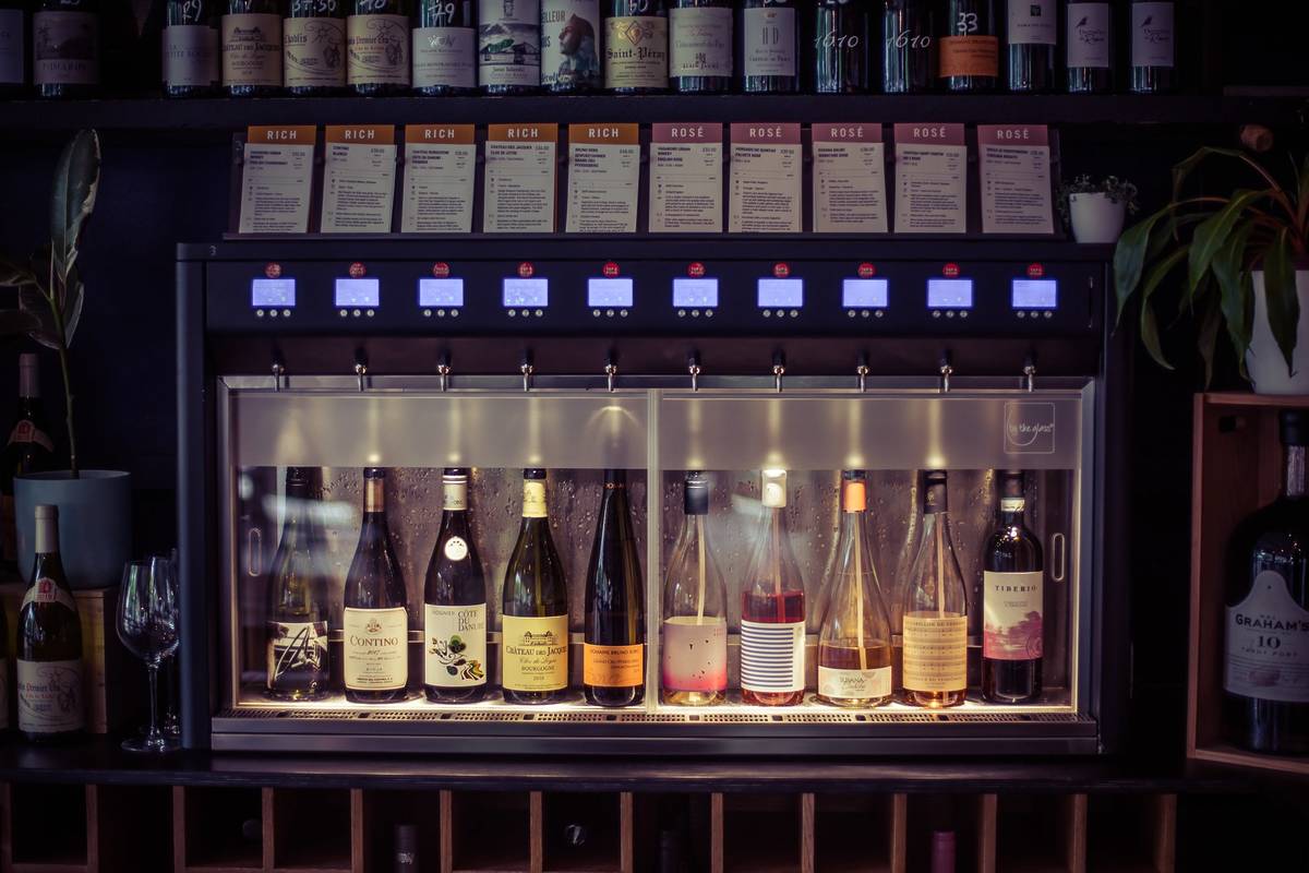 A row of wine bottles linked to the self serve vending machines at Vagabond