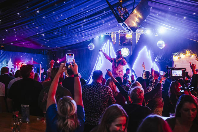 A crowd dancing inside the apres-ski inspired curling club