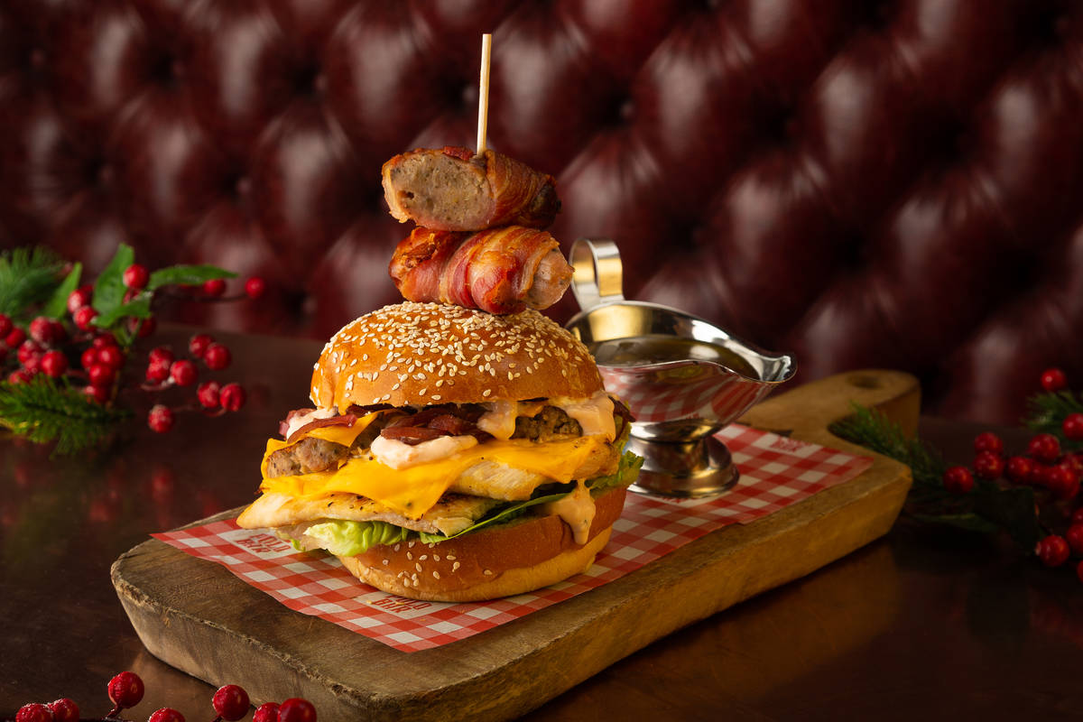 The festive burger at Polo Bar served on a wooden board surrounded by sprigs of holly