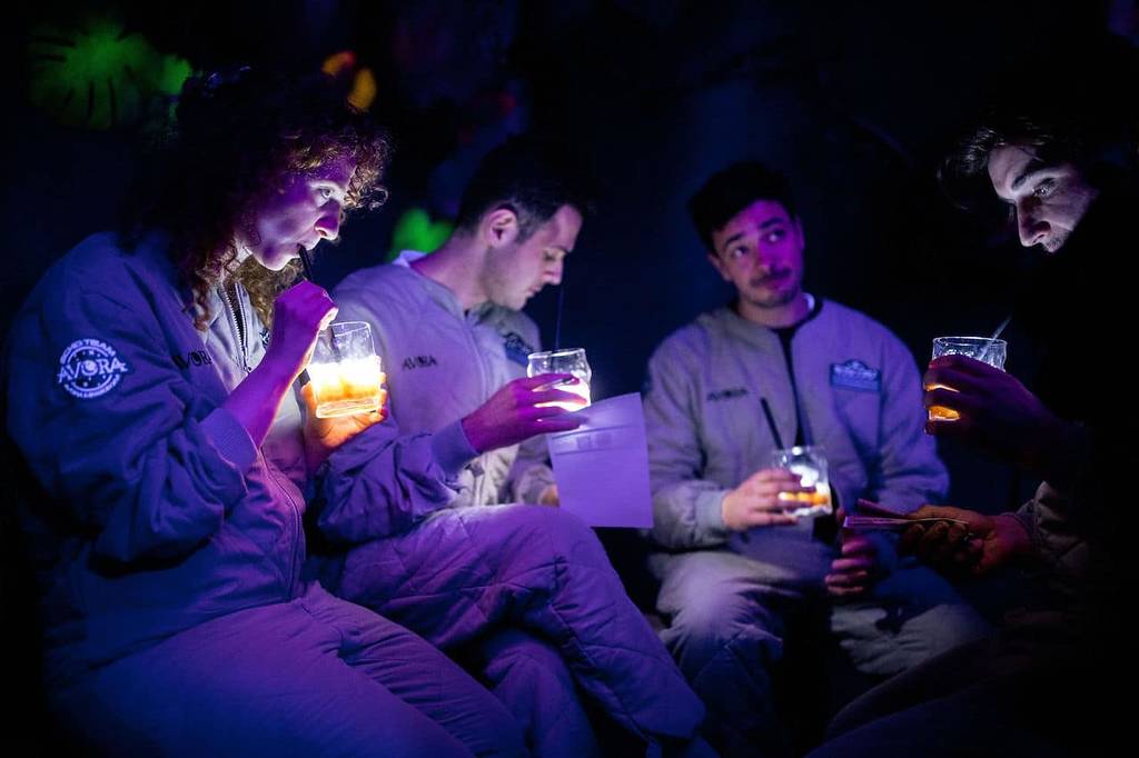 Friends enjoying cocktails at the immersive Avora experience in London.