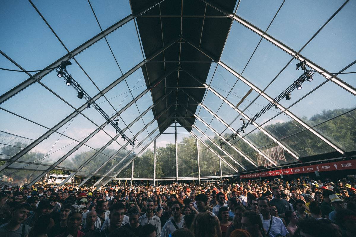 crowd standing under the greenhouse glass roof