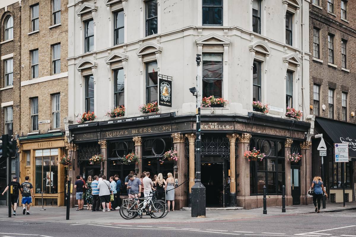 People standing and drinking outside The Ten Bells pub in Spitalfields