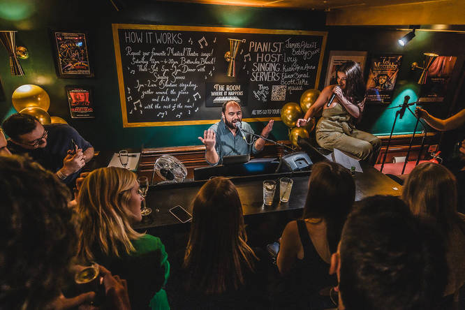 Piano player performing for the crowd at The Room Where It Happens in Soho, London.