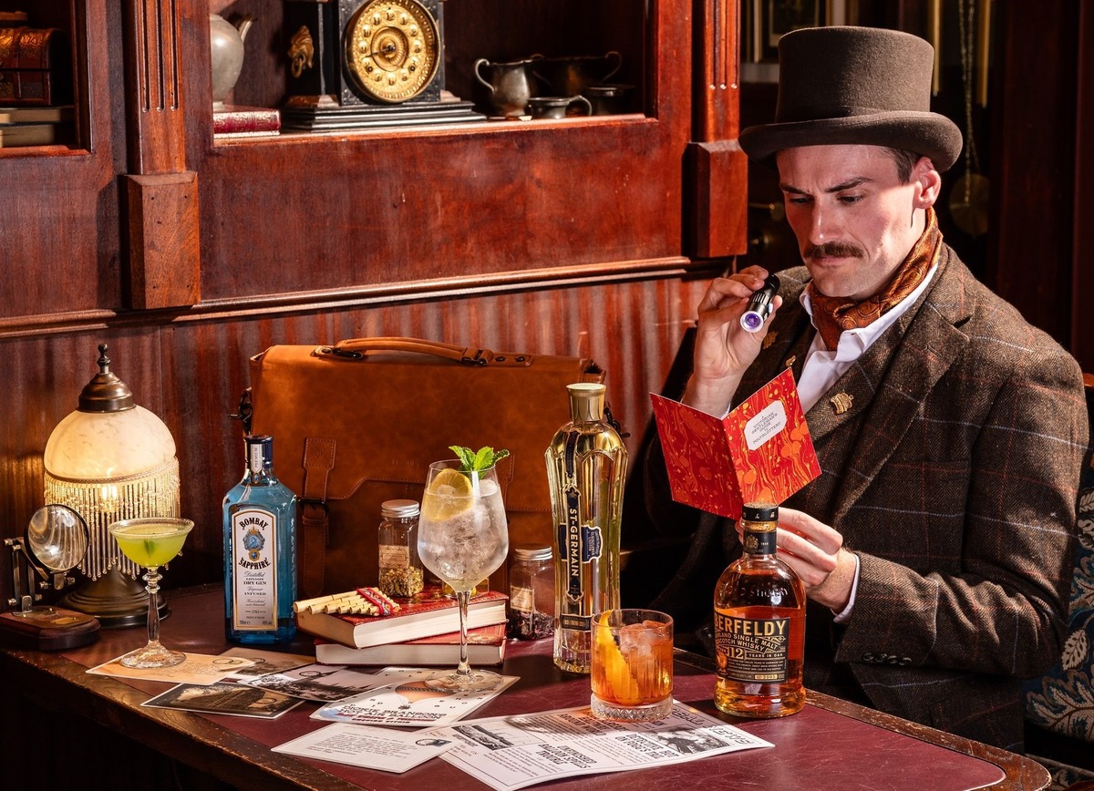Visitor at Mr. Fogg's Pawnbrokers with a selection of cocktails and bottles on the table