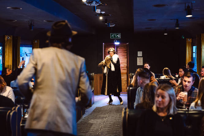 a person holding a toy dog in character on the Murder Express