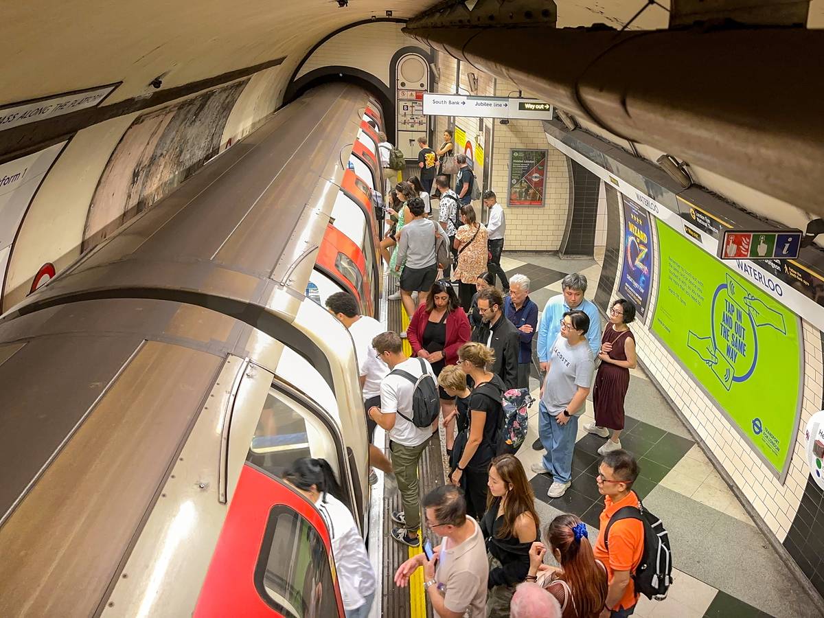Commuters getting onto a train on the London Underground