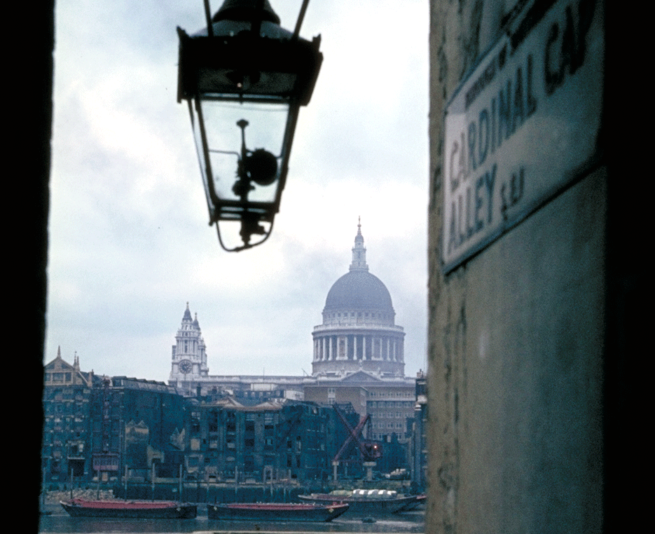 A view down one of Londons narrowest passageways with a view of st Pauls at the end