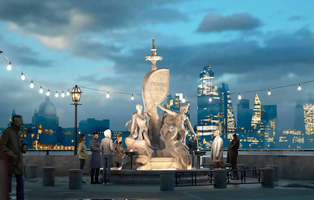 people gathered around a peroni themed and branded statue