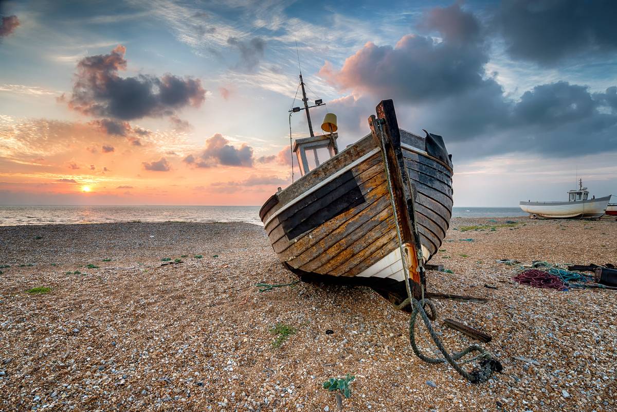 A beautiful sunrise over a wooden fishing boat at Dungeness