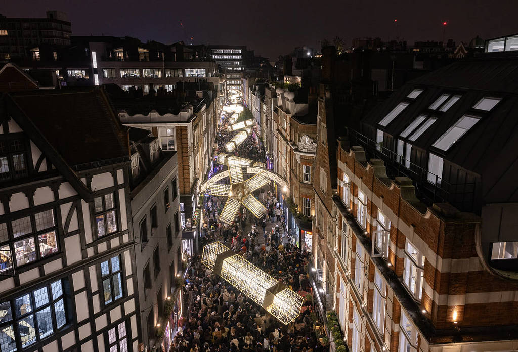 the new carnaby street christmas lights lit up over a crowd of people