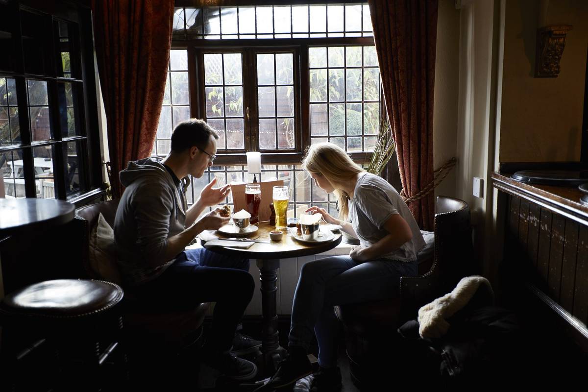 Customers enjoying food the "The Flask" pub in Highgate.