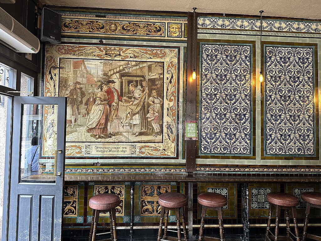 Tiled interiors with seating at The Ten Bells pub in Spitalfields, London.