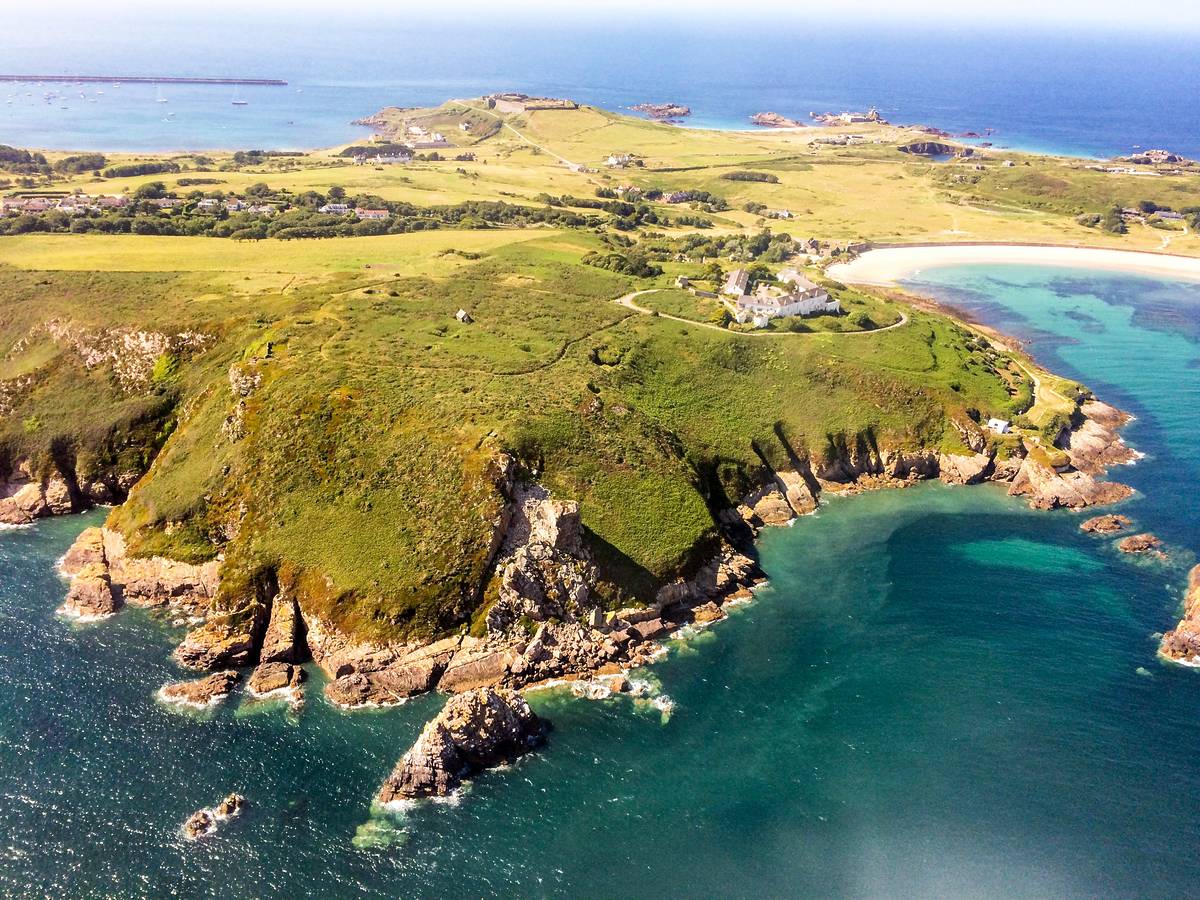 An aerial view of the island of Alderney, surrounded by sea