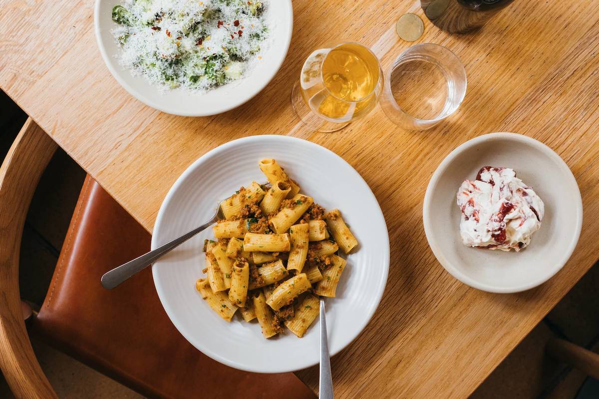 a plate of rigatoni pasta, salad and desert