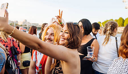 two people are taking a selfie on the top deck of a boat