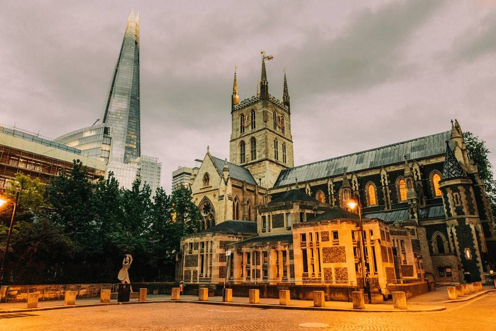 The exterior of Southwark Cathedral in London with The Shard in the Background.