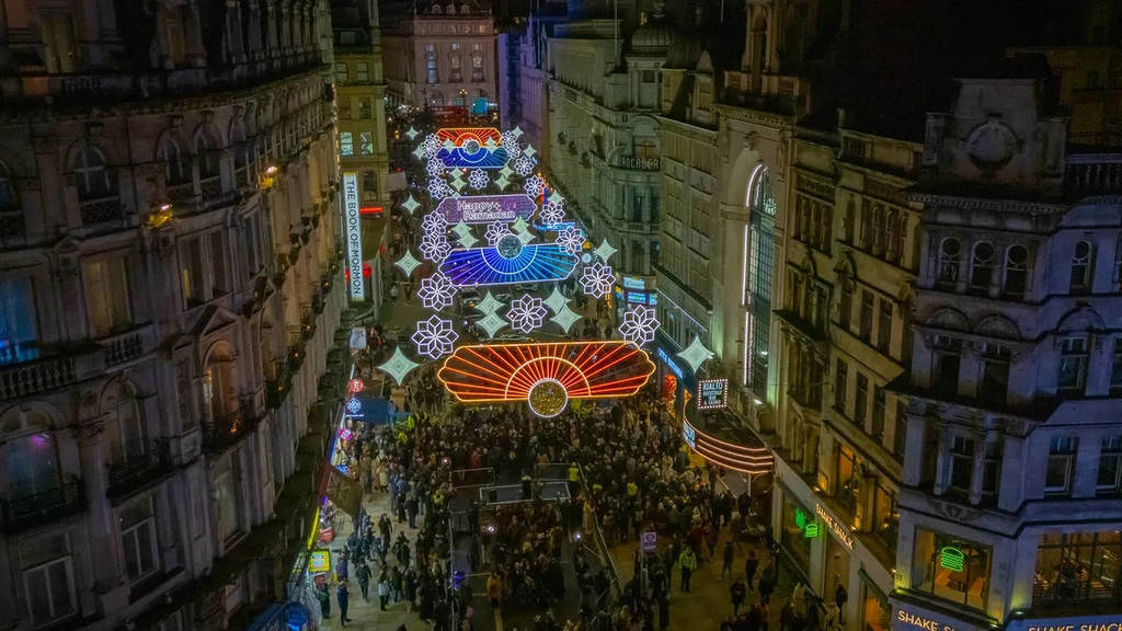 crowds of people underneath the ramadan lights in london's west end
