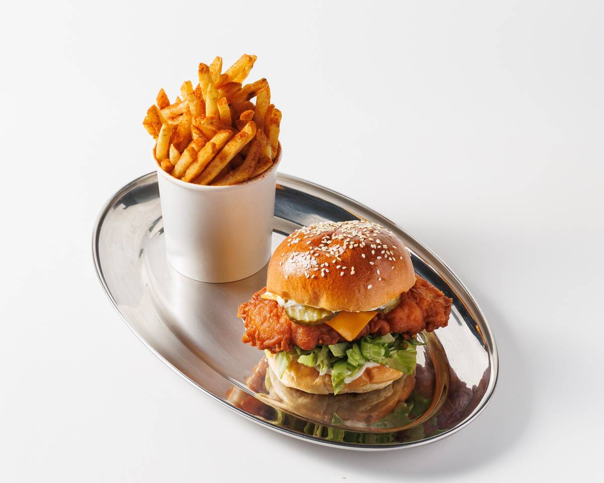 a portion of fried and a fried chicken burger