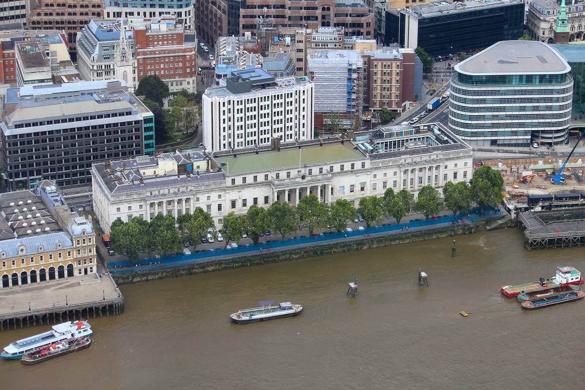 A birds-eye view of Custom House and the River Thames with a boat on it