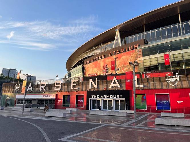 Shot of the Emirates Stadium in front of a blue sky in North London