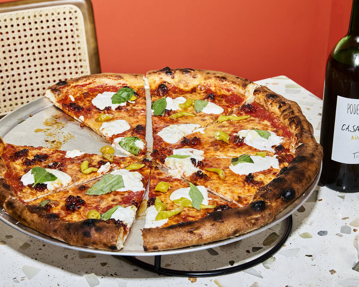 a sliced pizza on a raised platter