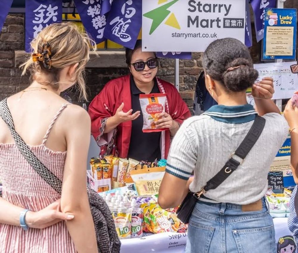 people buying things from a Japanese street market stall