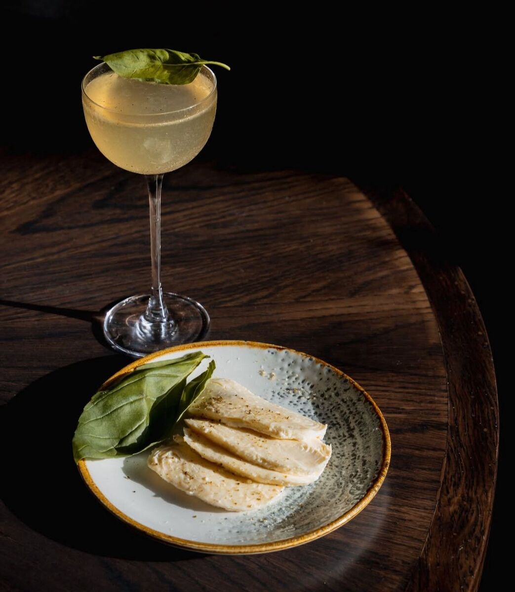 slices of mozzarella and a leaf of basil next to a 'margherita margarita'
