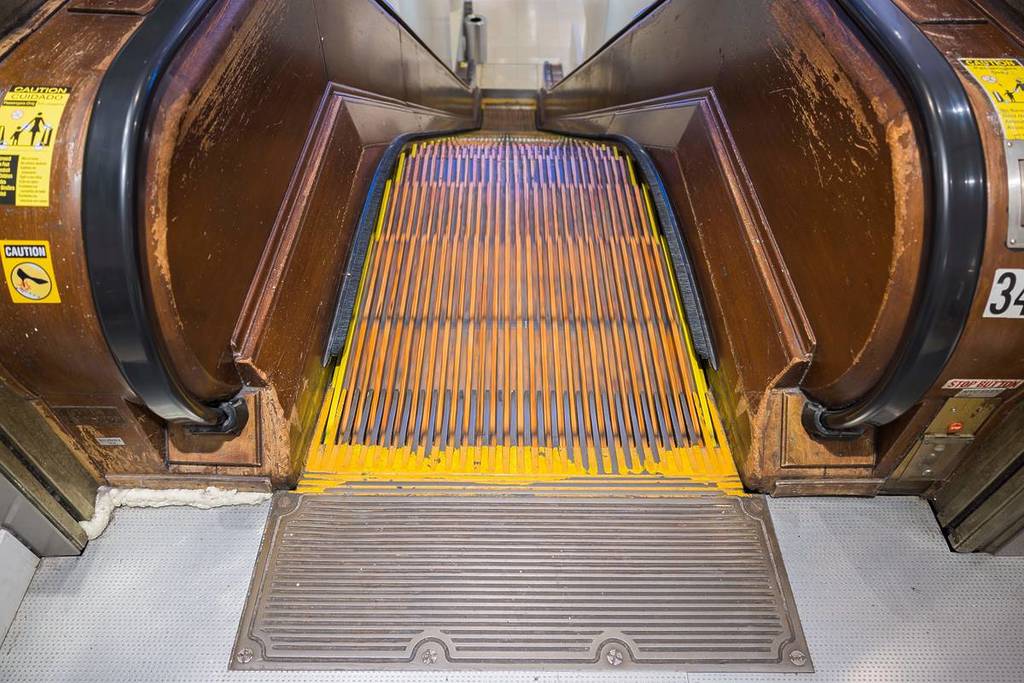 A close up of a wooden escalator