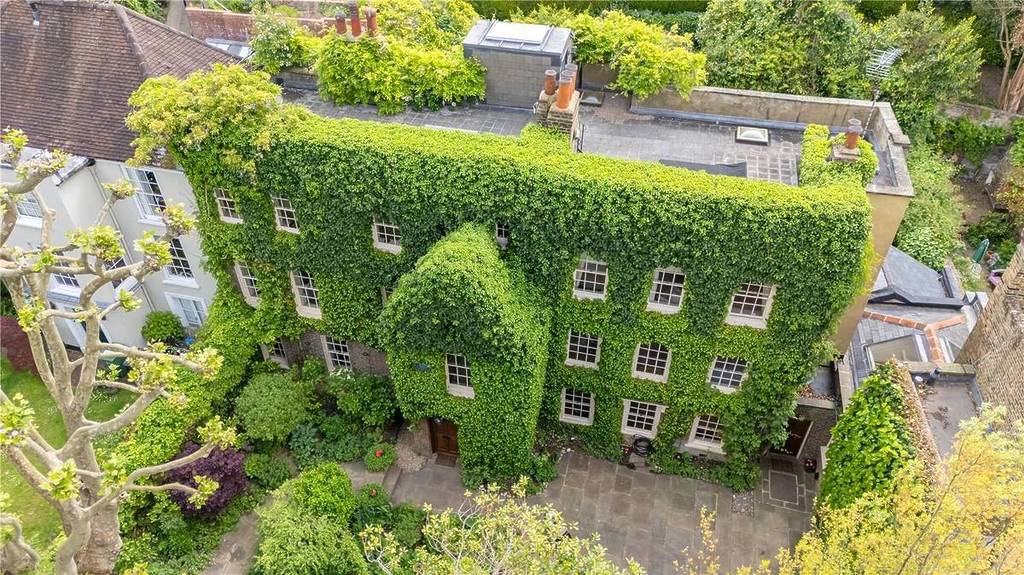An above view of a mansion in Hampstead completely covered in green ivy