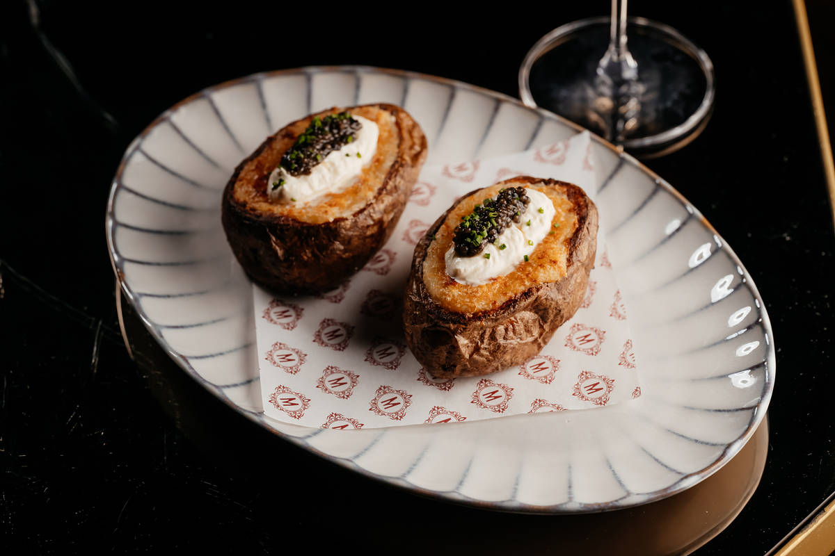 a jacket potato topped with creme fraiche and caviar