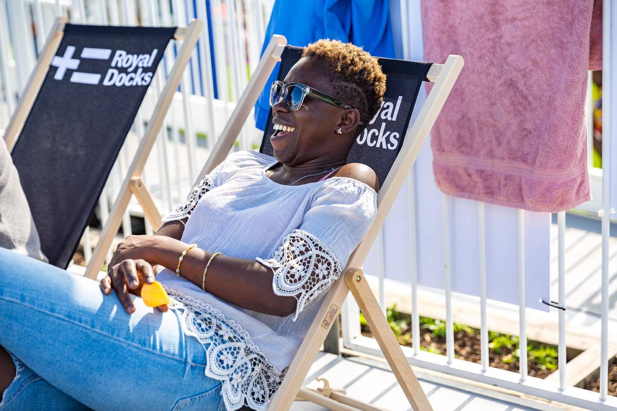 Someone relaxing in a deck chair at the Royal Dock lido