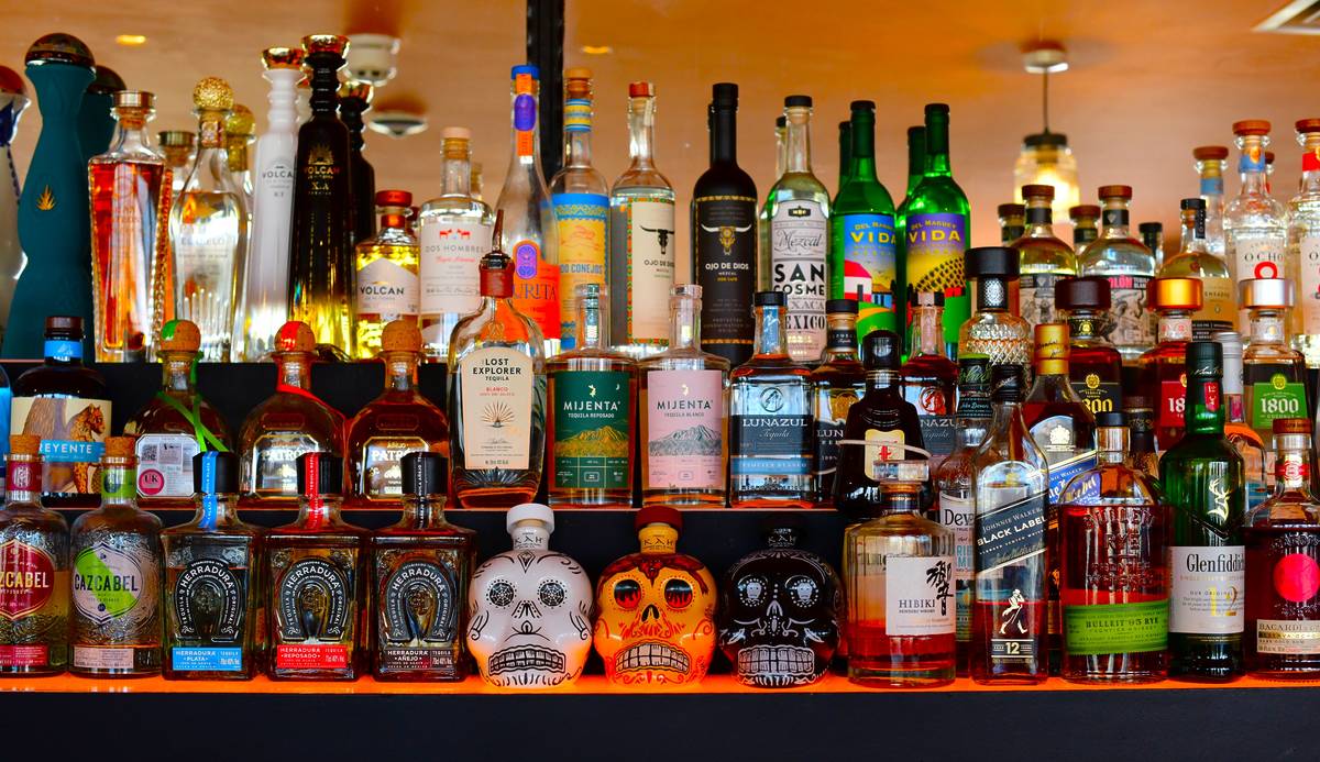 a hefty selection of tequilas on a bar