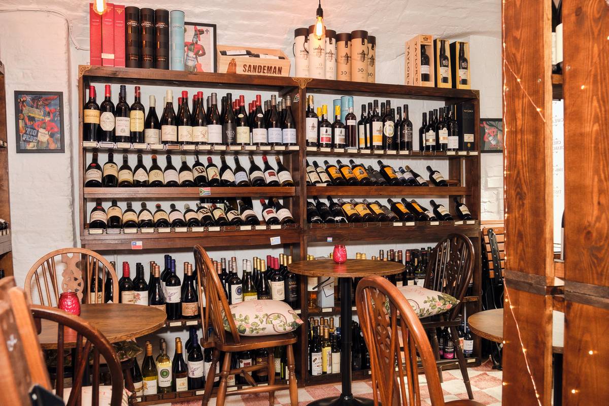 a shelf full of wine bottles at Courtyard Wine Cellars