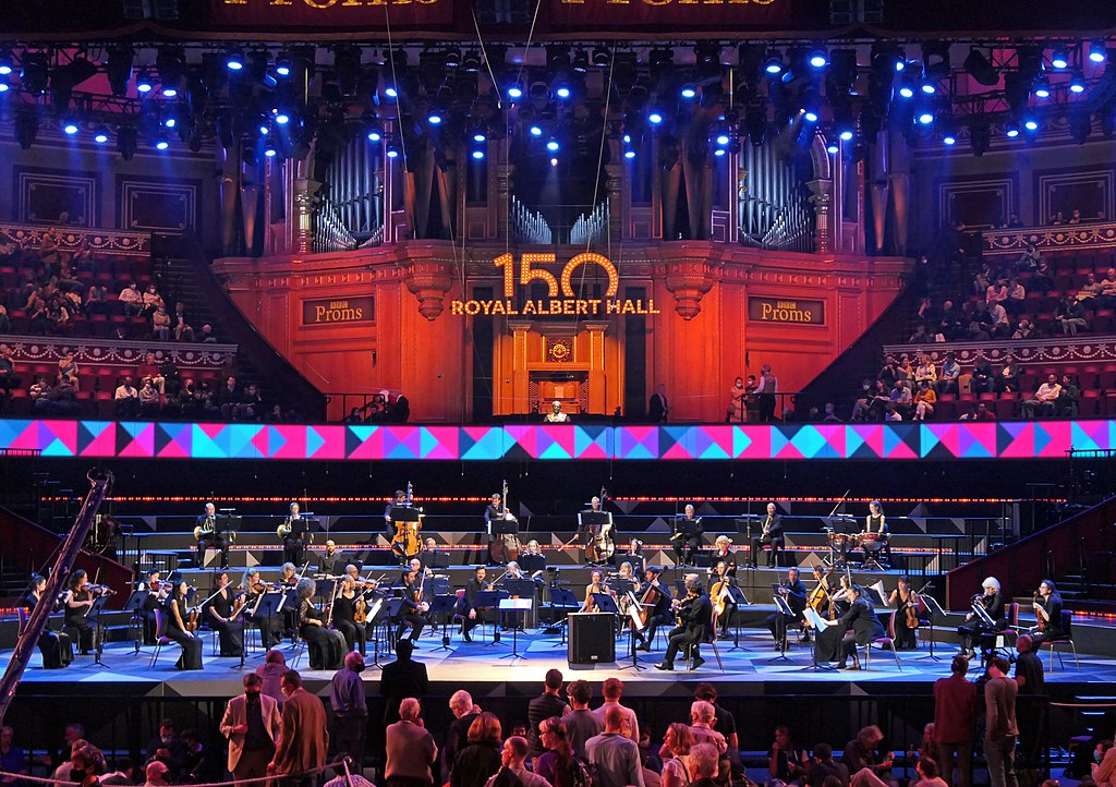 orchestra sits on stage at proms
