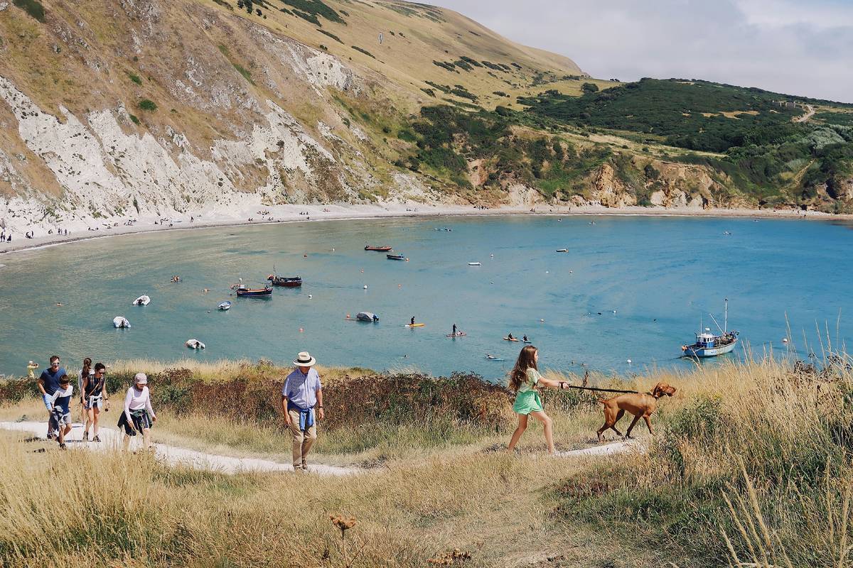 people walking on the coastal path by durdle door