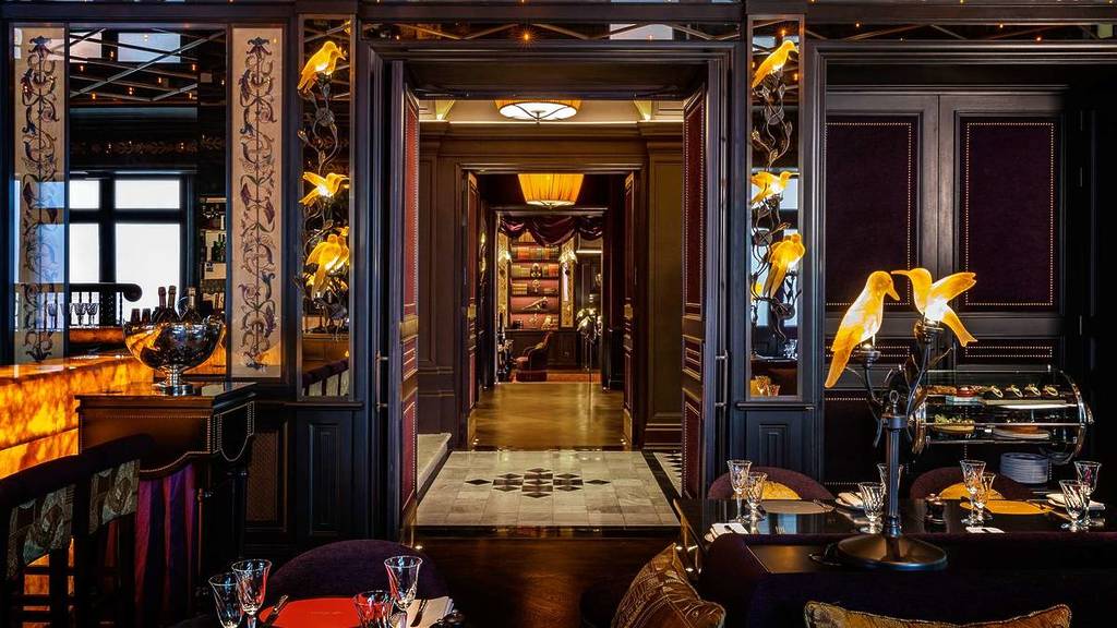 A view of the restaurant and entrance of the L'Oscar hotel decorated very opulently